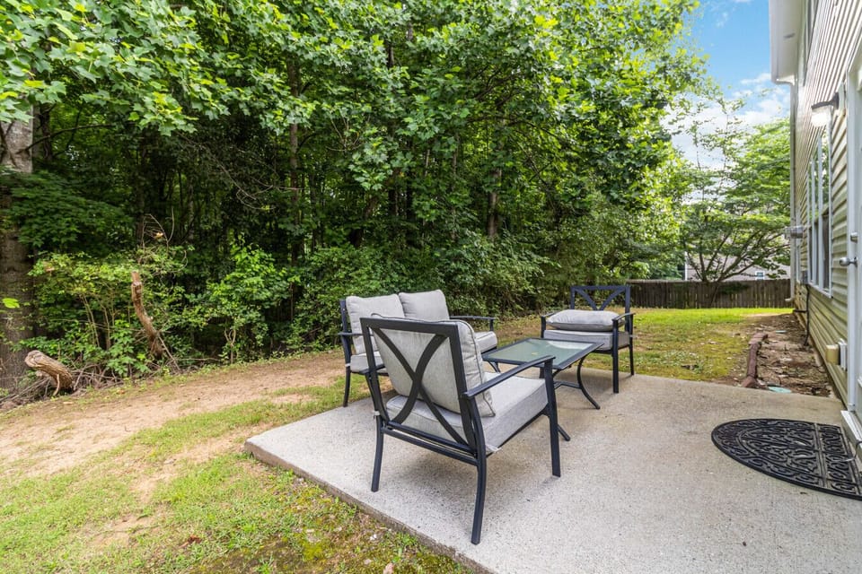 Spacious backyard featuring outdoor furniture and open space.