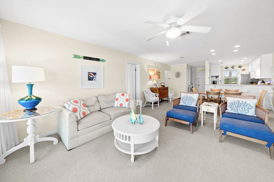 Relax in your bright living space with coastal touches, comfy seating, and an open layout perfect for gathering.