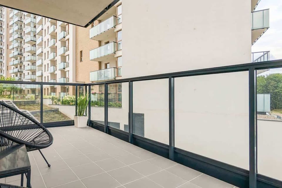A balcony with a modern railing is the perfect place for a morning coffee and enjoying the surroundings.

