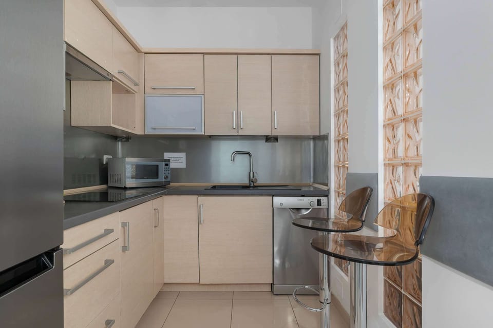 Fully equipped kitchen in a cream color.