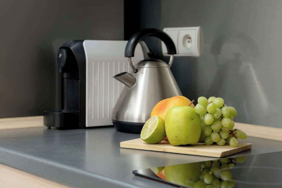 Close-up of fresh fruit and a kettle.