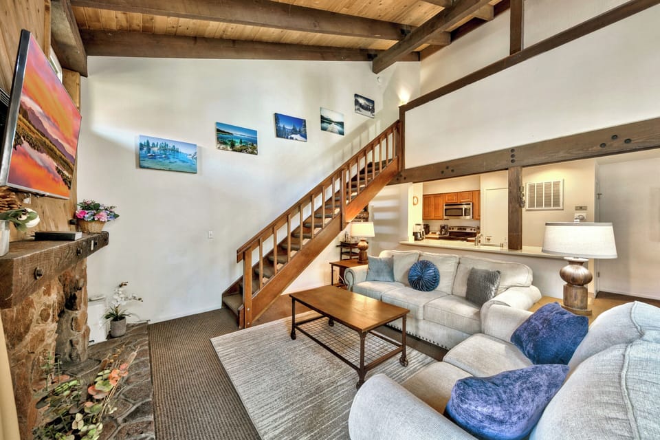 The loft overlooks the living room down vaulted wooden ceilings