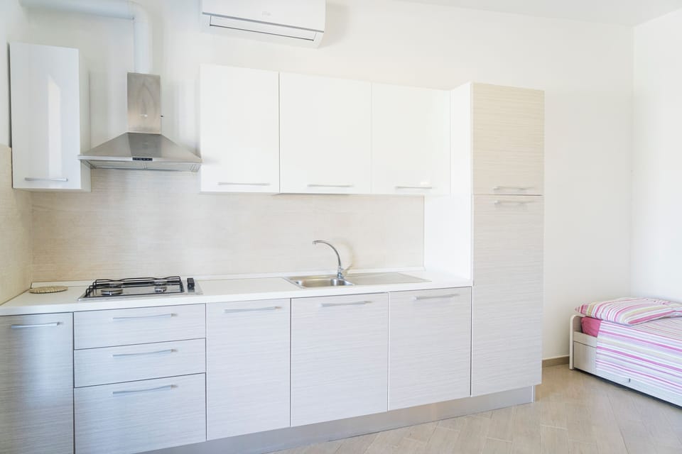 Superior Apartment, Garden View | Private kitchen | Full-size fridge, stovetop, highchair, cookware/dishes/utensils