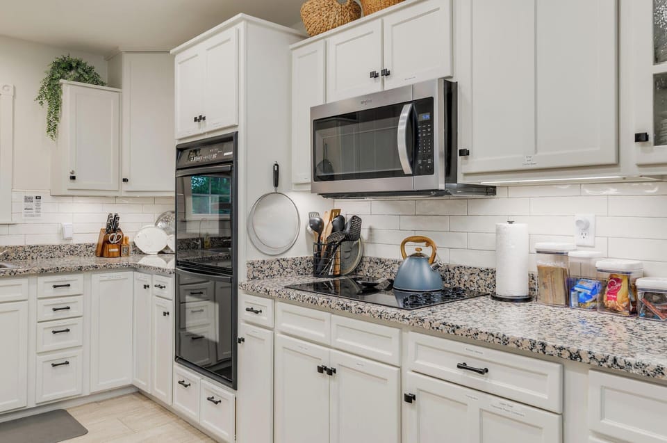 fully stocked kitchen with double ovens