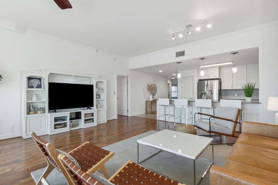 Stylish Living Space Featuring Flat Screen Smart TV with Cable, Balcony Access, and Stunning Views