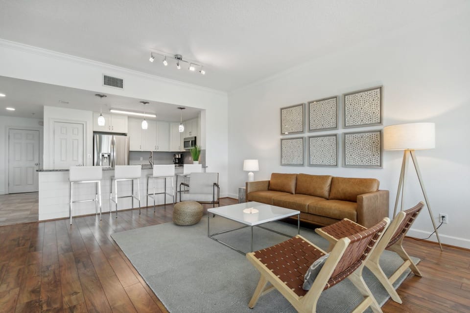 Stylish Living Space Featuring Flat Screen Smart TV with Cable, Balcony Access, and Stunning Views