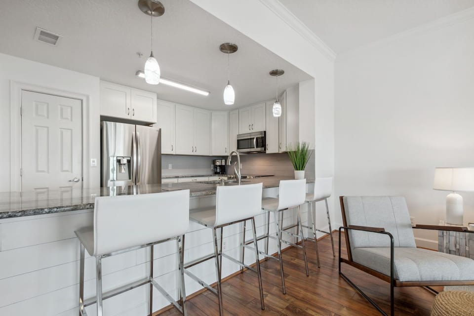 Sparkling White Kitchen with Seating for Four at the Counter Stools