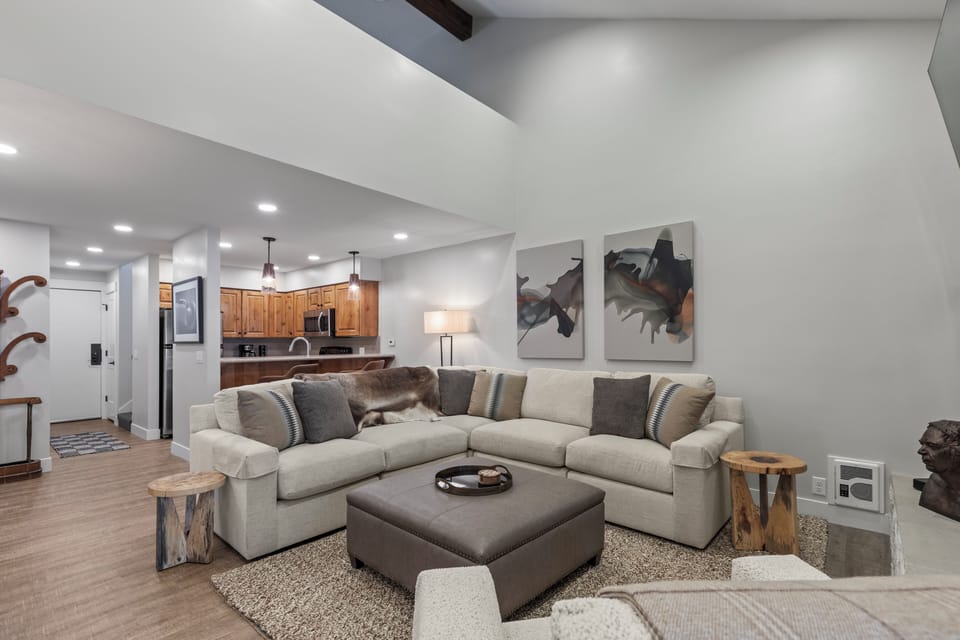 The open concept living room and kitchen area with stylish decor.