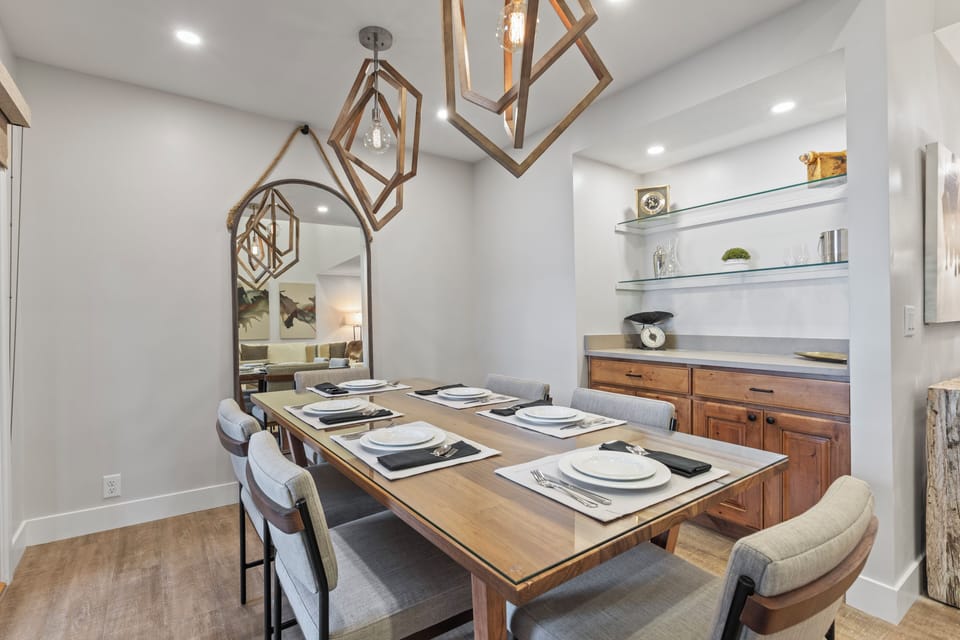 The dining area offers seating for 6 guests and has statement lighting.