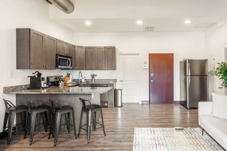 Enjoy home-cooked or the neighborhood's best takeout in this lovely kitchen with stainless steel appliances, a microwave, and a full-sized refrigerator