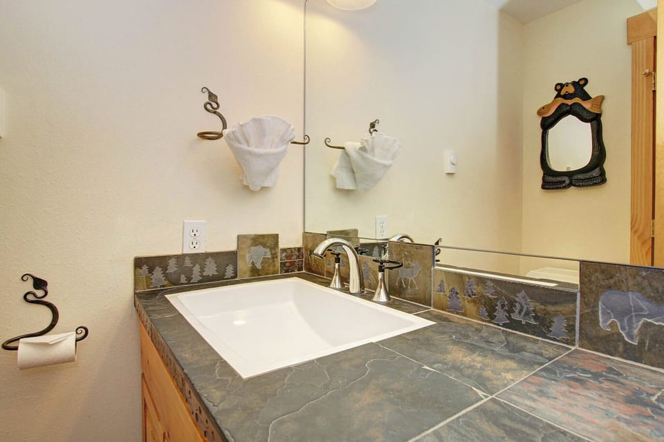 Beautiful mountain-themed powder room adjacent to kitchen/living space.