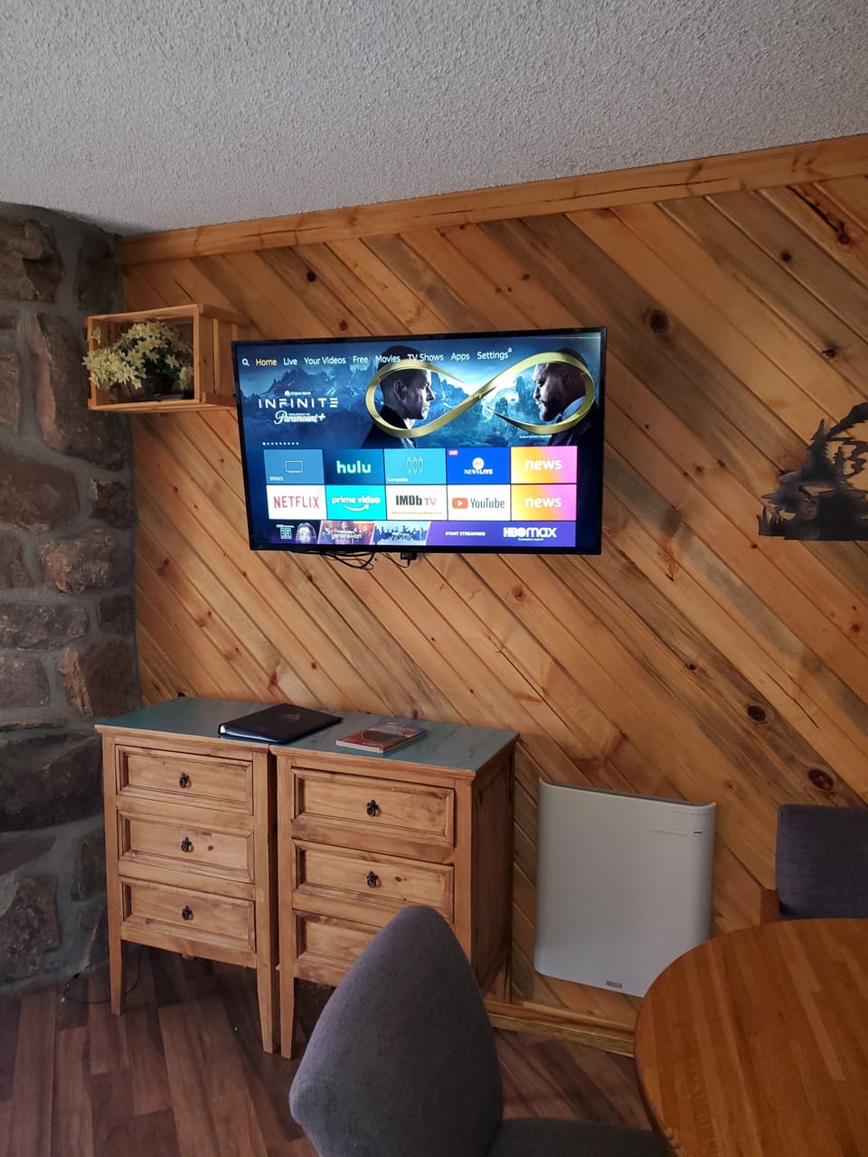 43" Amazon fire tv next to fireplace and kitchen