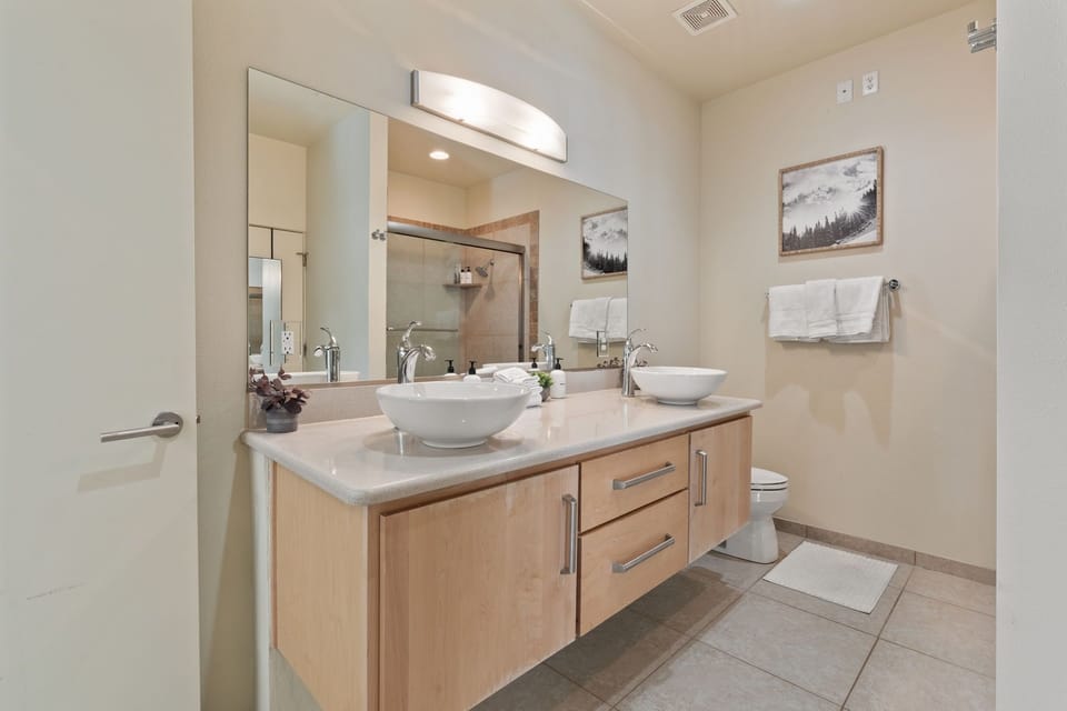 The bathroom includes a double sink, a shower/tub combo, a large walk-in closet, and all the essentials for a comfortable stay! | The Hillside, Brian Head, Utah | Voyax Luxury Vacation Rentals