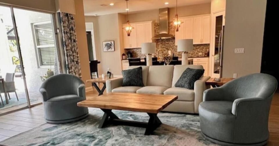 Living area with triple sliding glass doors to lanai and pool