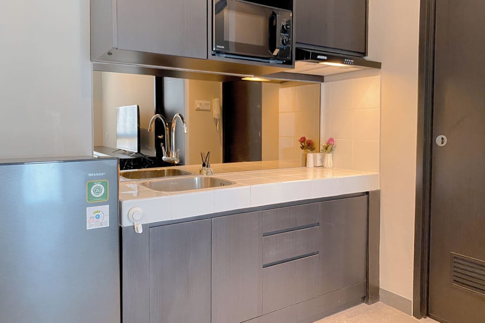 Deluxe Apartment | Private kitchen | Fridge, microwave, stovetop, dining tables