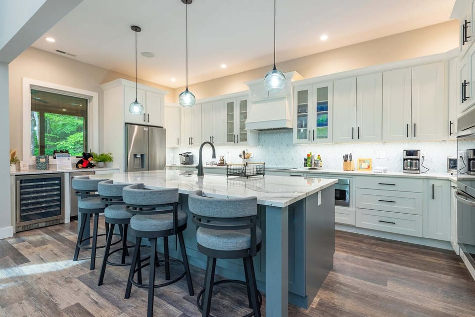 Deluxe chef's kitchen with high-end appliances, double oven, dishwasher, wine cooler, and Drip-style coffeemaker