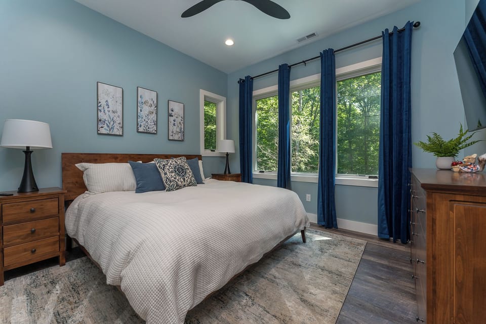 Main level bedroom with King bed, Smart TV, and en suite bath.