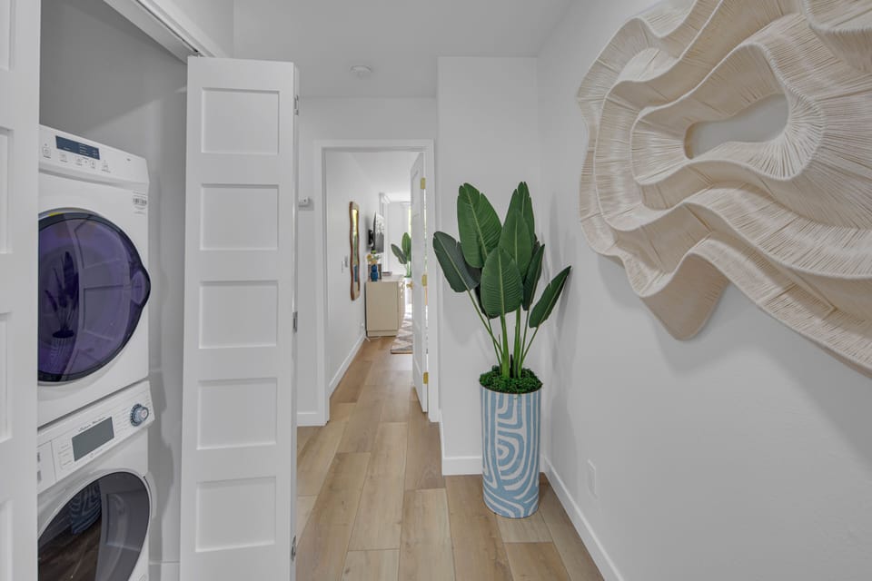 Hallway from living areas to bedrooms and hall bath. There is a washer and dryer in the hallway as well.