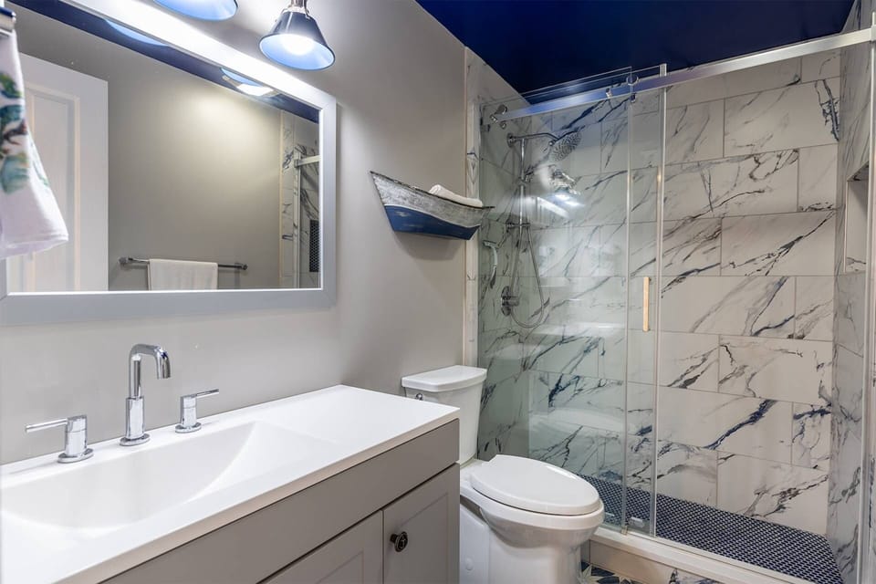 The full bath in the first floor unit has a custom tile stand-up shower.