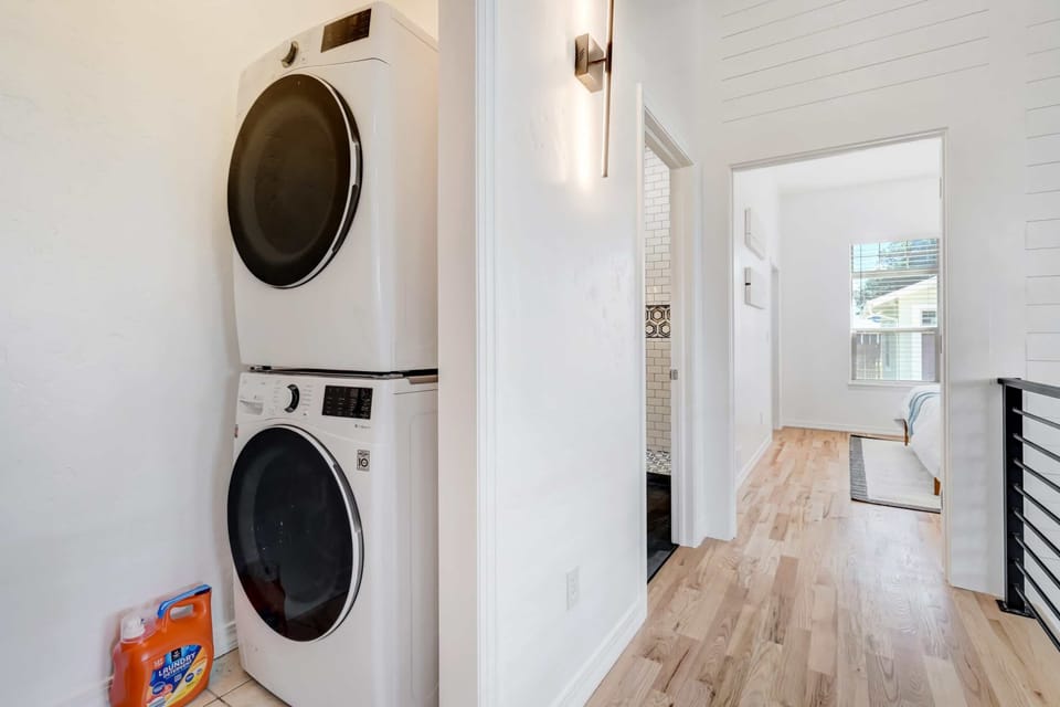 Laundry area with a stacked washer and dryer.