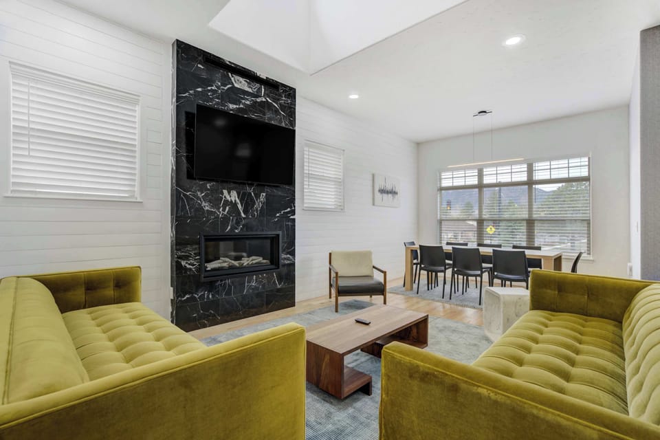 Welcome to Vista Montana! Our modern retreat in Historic Downtown Monument, your perfect getaway! Enjoy our inviting living room with large windows, a decorative fireplace not available for use , and cozy seating for relaxation.