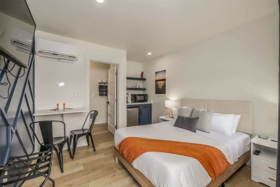 Your apartment has a cute kitchenette with coffee maker, microwave, mini fridge, coffee pot, dishes, utensils, and storage