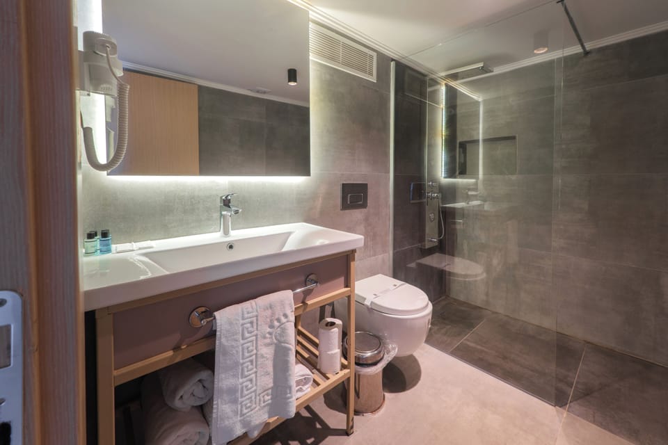 Family Duplex, Balcony, Garden View | Bathroom | Shower, hair dryer, slippers, towels