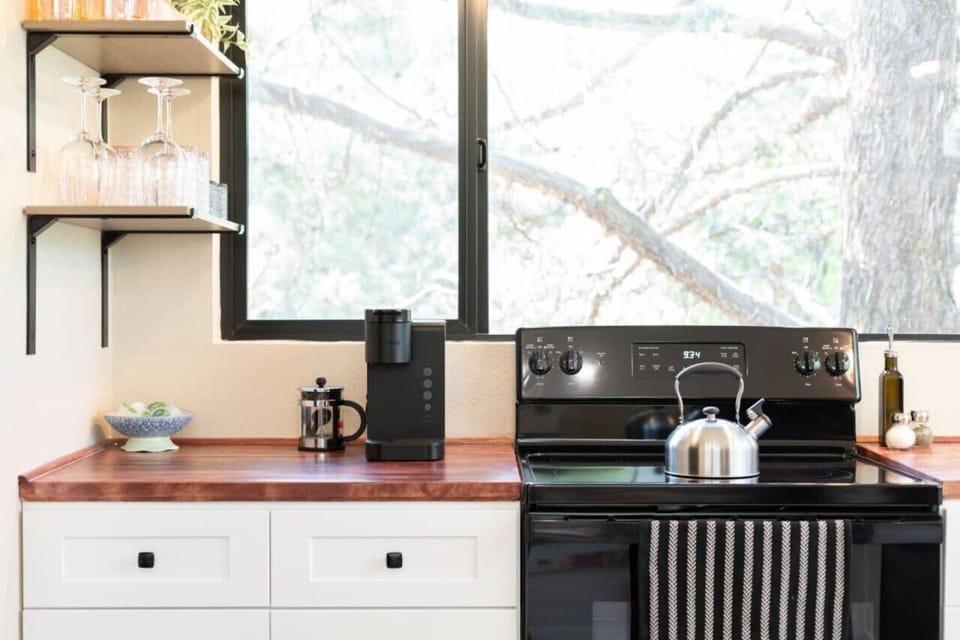 Sunlit kitchen with modern appliances and chic decor for your culinary delights!