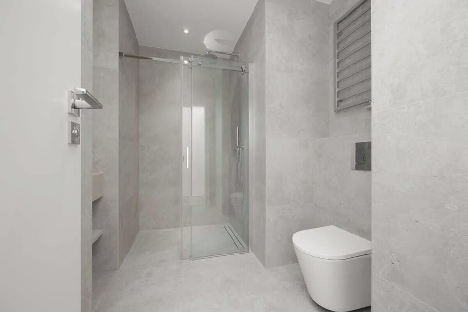 Walk-in shower bathroom with light tiles, modern fixtures, and minimalist style.