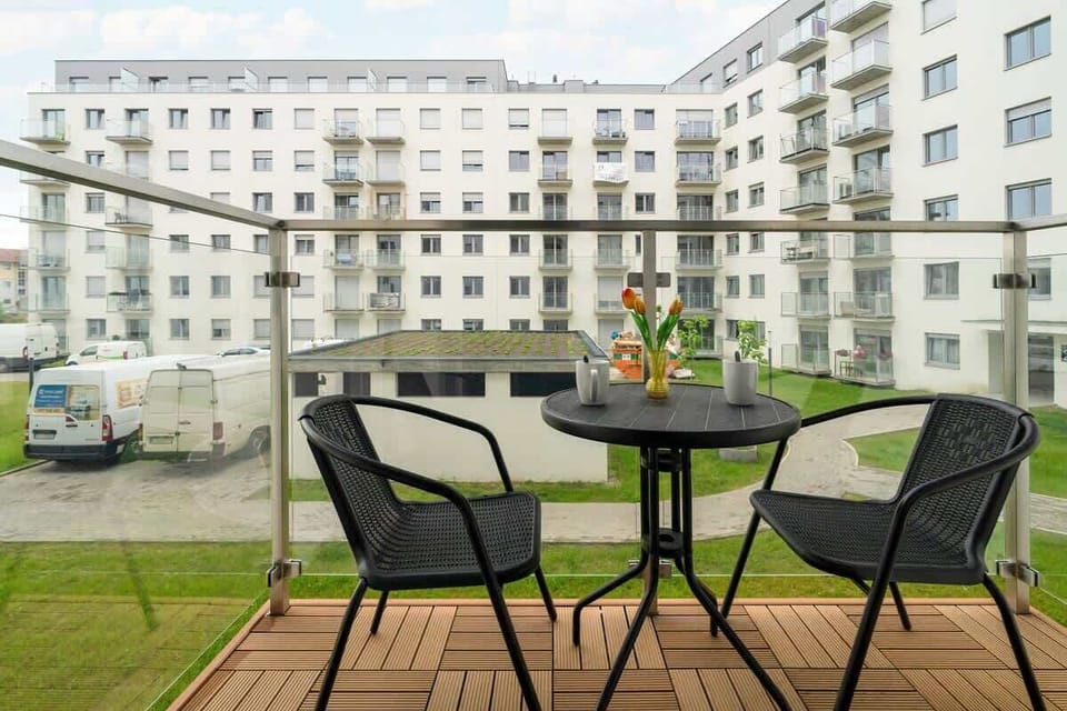 A private outdoor sitting area with woven chairs and a wooden deck, perfect for enjoying morning coffee or evening relaxation.