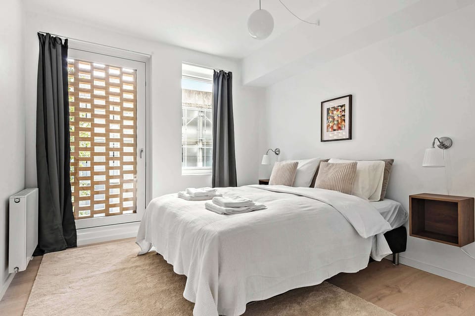 Bedroom with floor carpet and blackout curtains