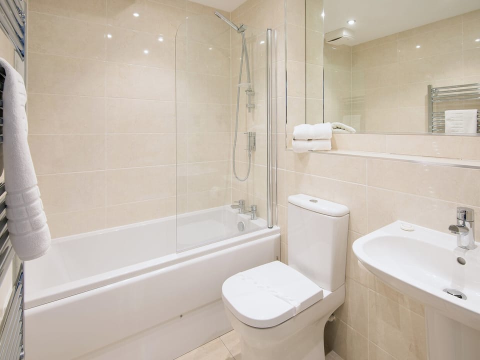 Contemporary bathroom equipped with white bath suite | Spindrift, Seahouses