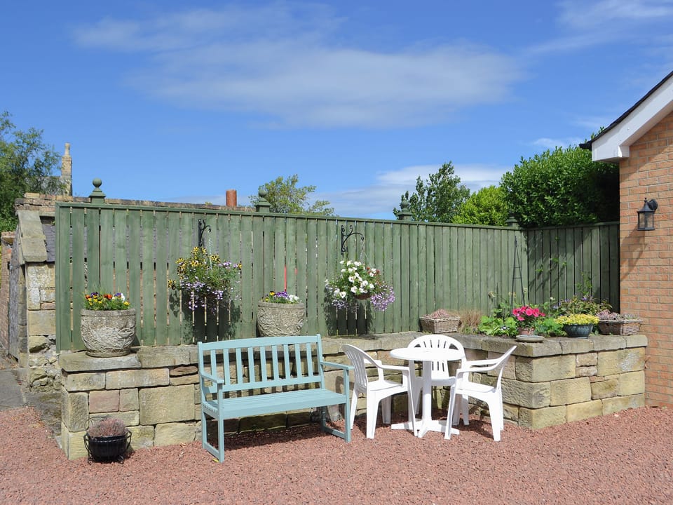 Gravelled patio with outdoor furniture at rear | Barkers Cottage, Ellington, near Druridge
