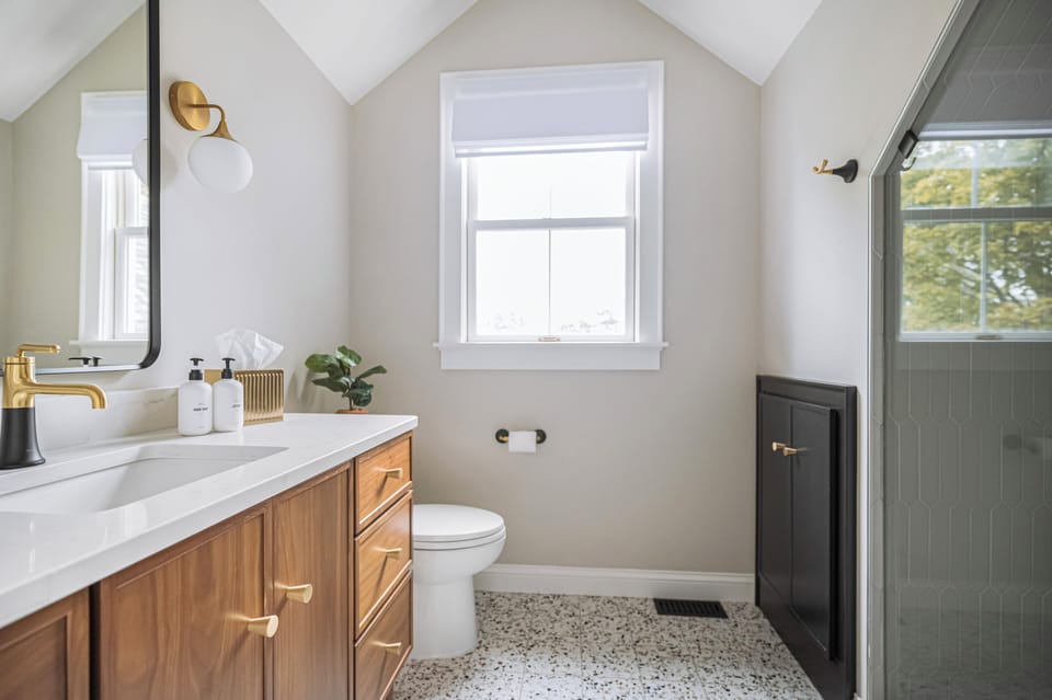 Indulge in this serene bathroom with lake views and a luxurious shower. 