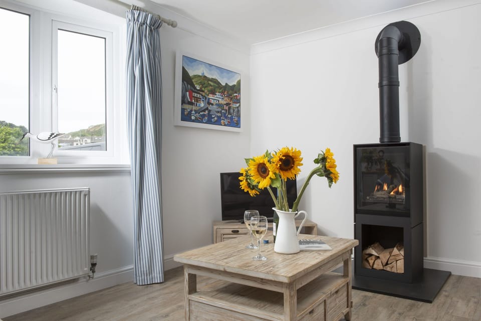 Castaways, Porthtowan. Ground Floor: Watch the rolling waves whilst you stay snuggled beside flickering flames