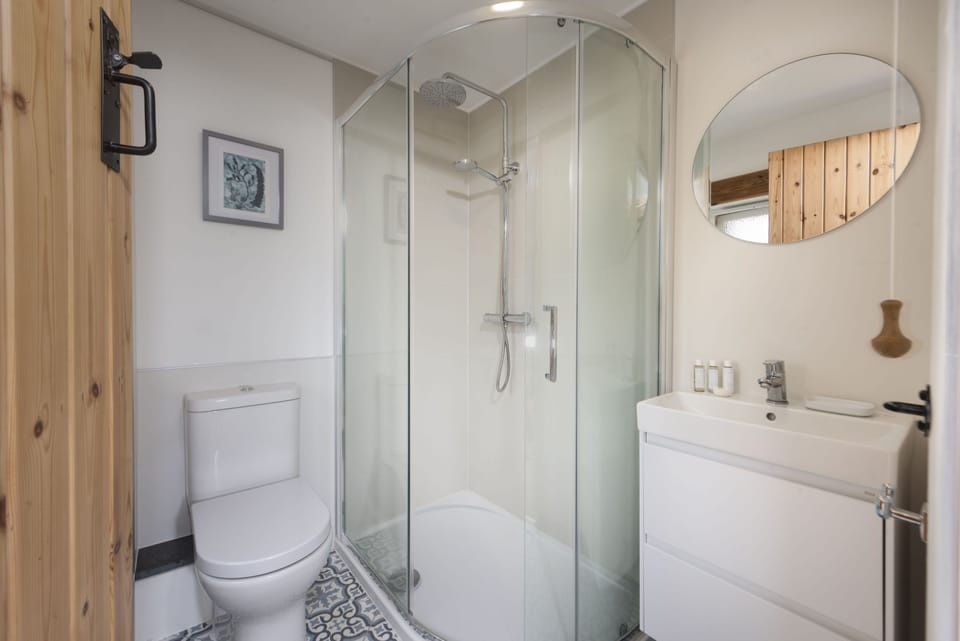 Bowjy Cottage, St Agnes. Second Floor: The family bathroom is complete with a shower, wash basin, heated towel rail and WC