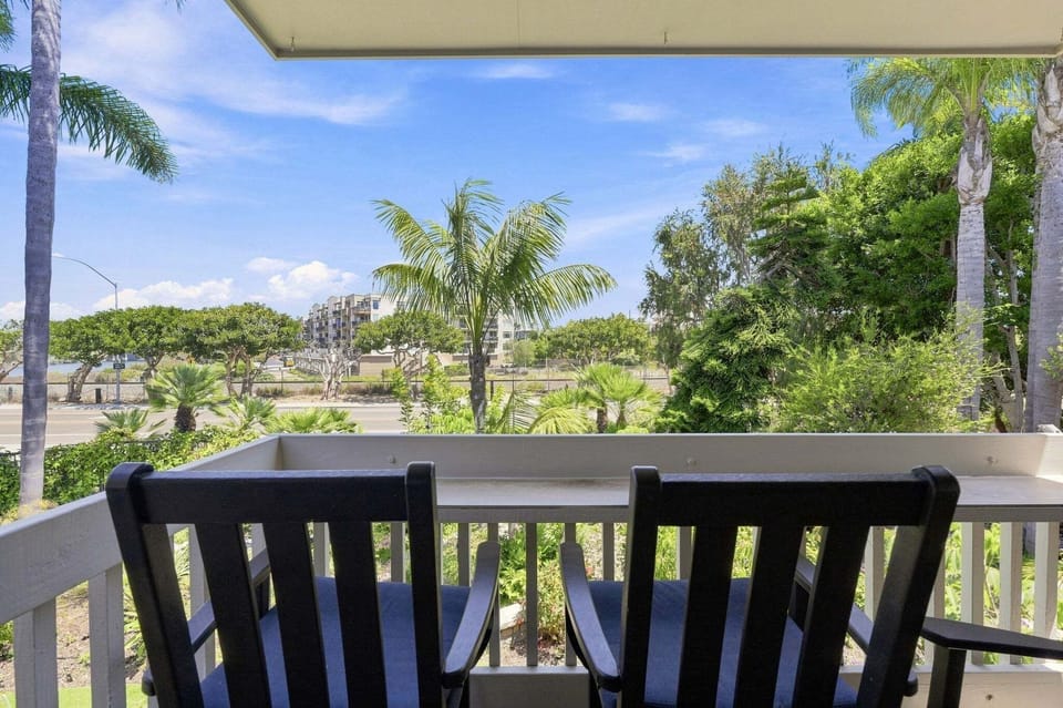 The balcony provides a bar area for dining  or enjoying a cup of coffee.