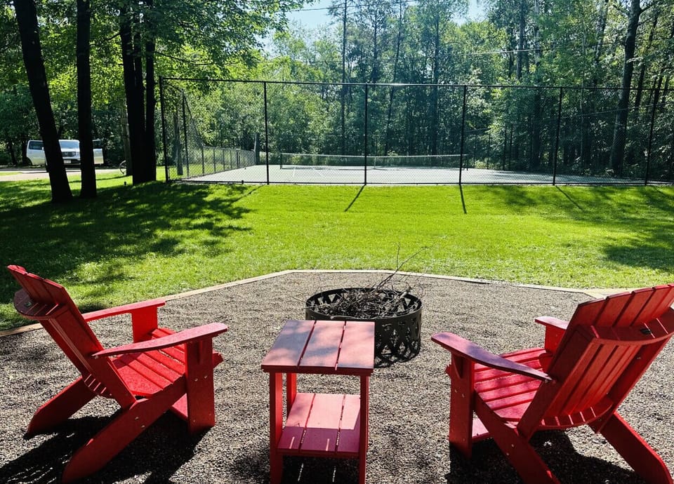 Fire pit facing the yard and tennis court