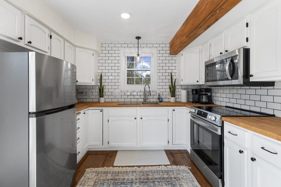 Full kitchen including fridge, range, microwave and countertop dishwasher