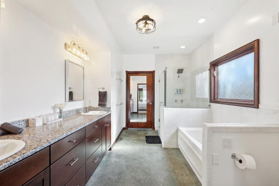 Large bathroom with dual sinks and walk-in shower.