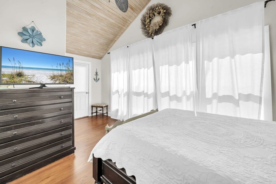 Upstairs BR with queen bed, tv, balcony and ensuite bath.
