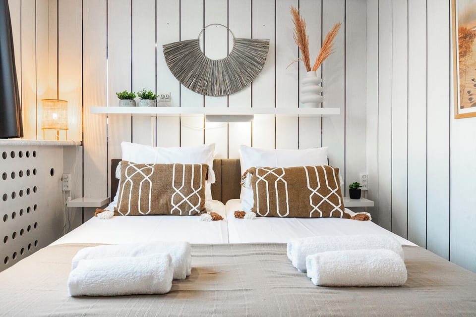 The room features twin beds with comfortable pillows, fresh towels, and tasteful decor, creating a cozy and inviting atmosphere. Thoughtfully designed, it includes proper lighting to ensure a pleasant and relaxing stay.