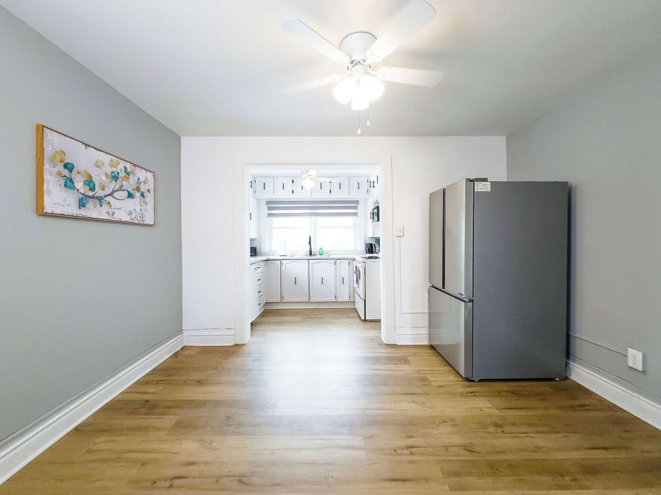 A Bright And Spacious Dining Area Leading Into A Modern Kitchen