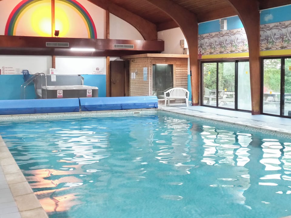 Shared swimming pool | Sunnybank Lodge, Llanfynydd