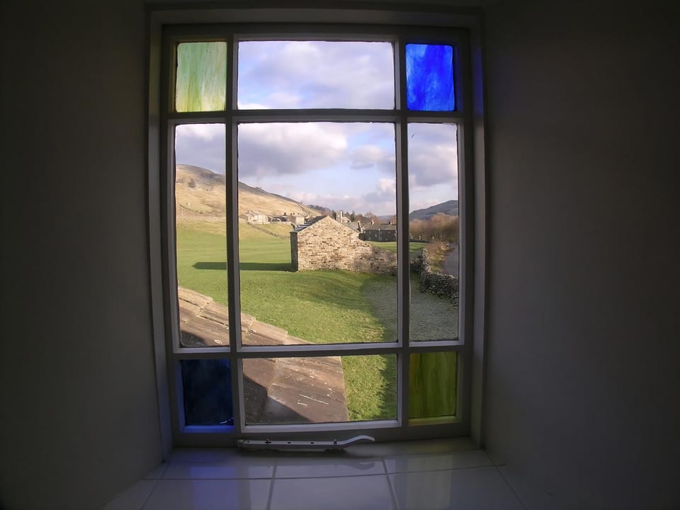 Traditional stained glass window with stunning country view | Arngill, Muker