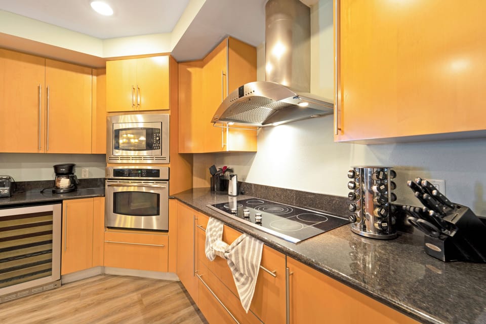 Glass stove top and range hood vents to building roof