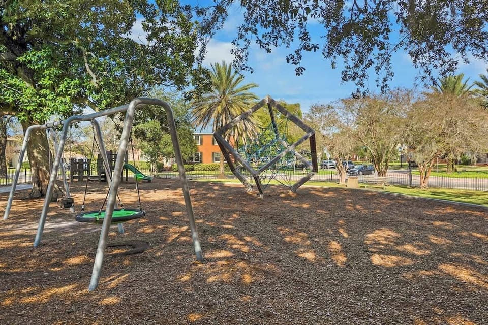 Neighborhood playground with swings, rope climber, and shaded mulch area — kids are already asking when they can come back. 3 blocks away!