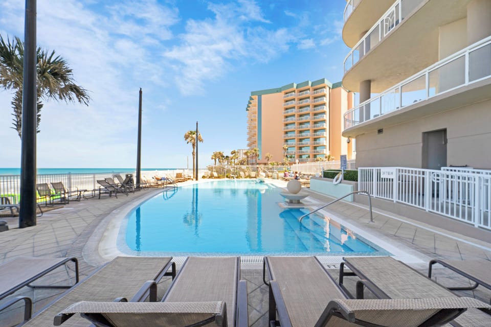 Shared oceanfront heated pool with lounge chairs