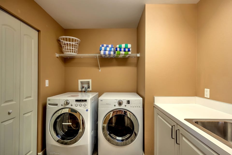 In unit laundry room with beach towels