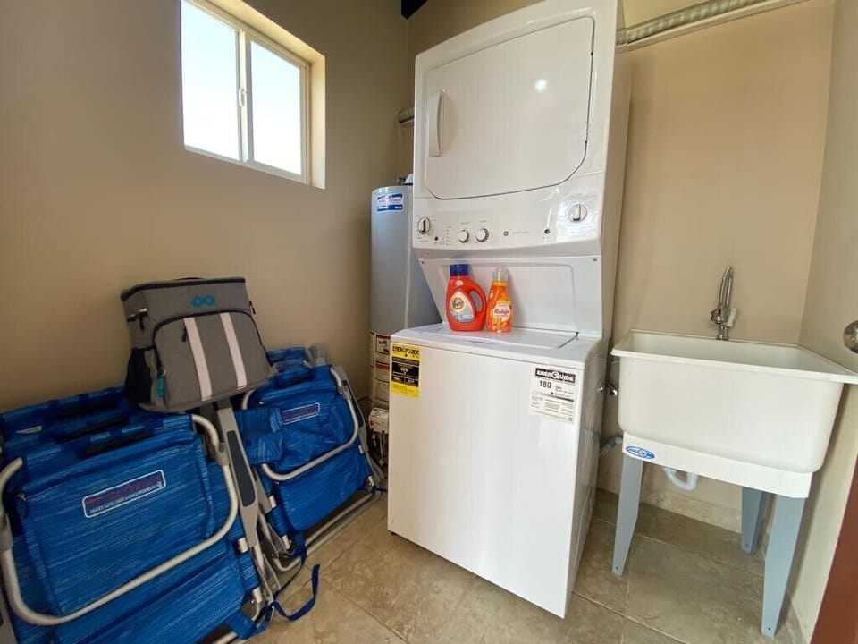 Conveniently located, the laundry area is fully equipped for your stay, complete with beach chairs and a cooler for your beach outings. Keep your vacation effortless and ready for adventure.